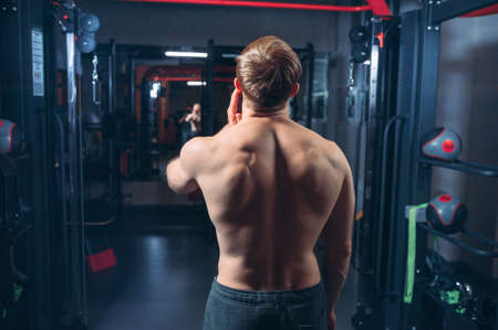 Handsome Man Standing Strong In Green T-shirt And Army Pants Flexing Muscles - Muscular Athletic Bodybuilder Fitness Model Posing After Exercisesの写真素材