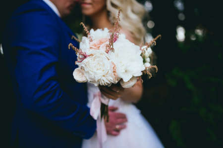 the bride and groom walk in nature. weddingの写真素材