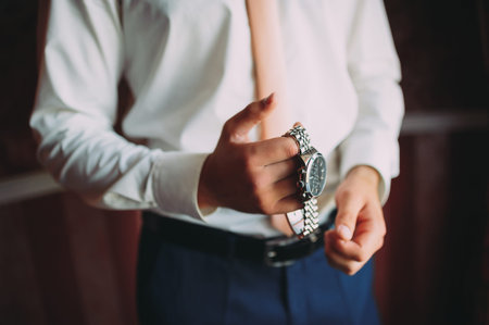 wedding preparations of the groom. clock. groom accessories