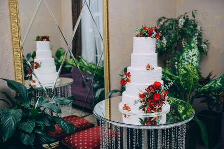 beautiful tiered wedding cake with fresh flowersの写真素材