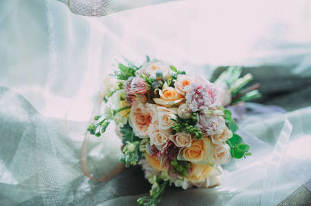 beautiful wedding bouquet of different flowers on blue backgroundの写真素材