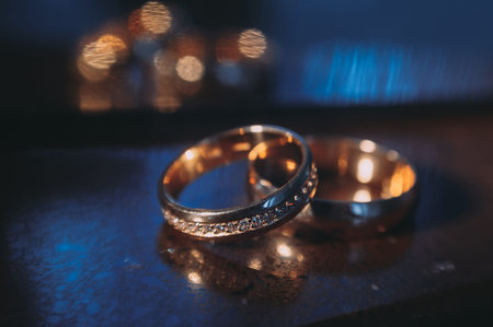beautiful golden wedding rings on sparkling background