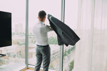 grooms wedding preparations. getting dressed and getting readyの写真素材