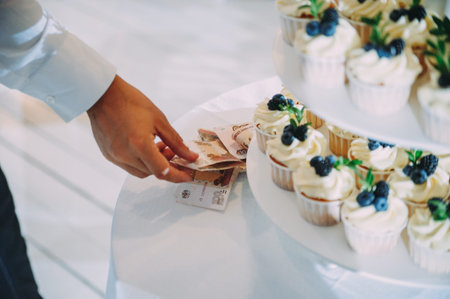 White wedding cake with flowers and blueberries