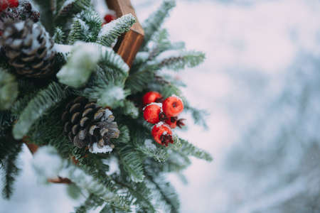 Winter photo shoot love story in a snowy forest. Candle decor gingerbread cones in the snowの写真素材