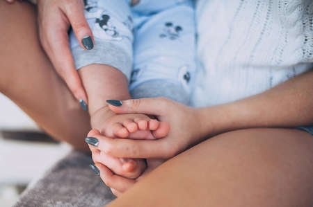 babys legs, babys and moms hands are interlacedの写真素材