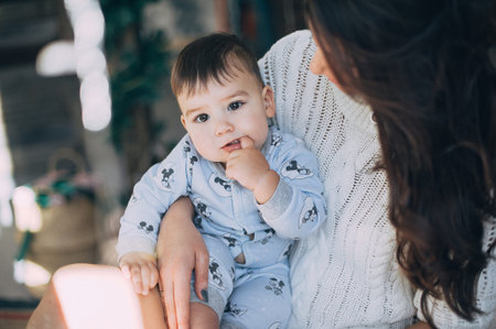 mother with baby on the bed in the studio