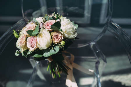 beautiful wedding bouquet of different flowers on a chairの写真素材