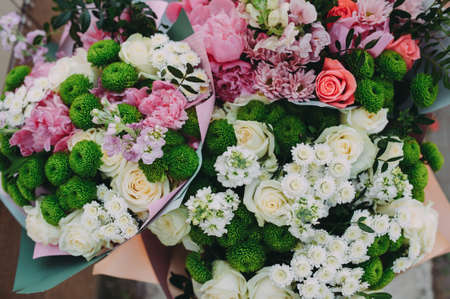 Pansy bouquets in three different colors, decorated with ivyの写真素材