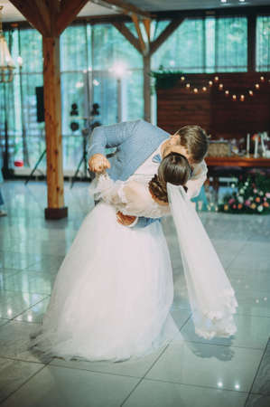the first dance of the newlyweds at a wedding in a restaurant. kissの写真素材