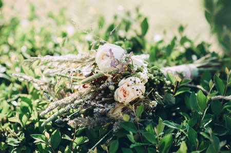 bridal bouquet of wildflowers lies on the bushesの写真素材