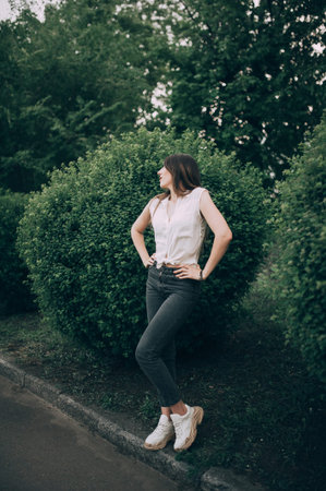 stylish brunette in jeans and sneakers posing Vogue Styleの写真素材