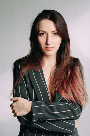 Portrait of a beautiful business woman, over a gray backgroundの写真素材