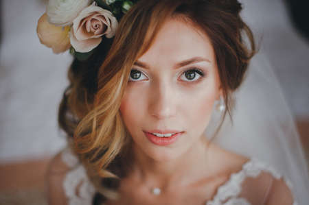 .Portrait of a beautiful bride on morning preparations at the hotel. looking at the cameraの写真素材