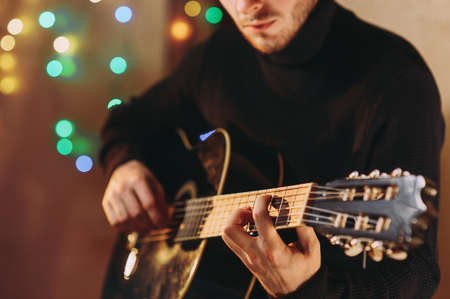 the guy plays the guitar. close-up of handsの写真素材