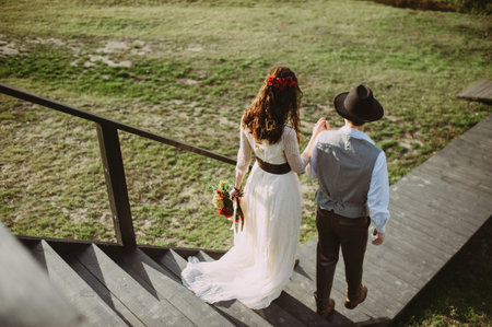 Happy husband and wife. Wedding day. Beautiful nature. Walk during the photo session. Holding handsの写真素材