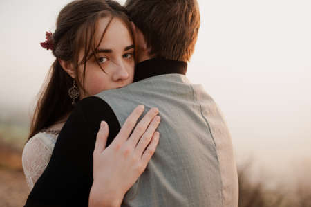 farewell hugs of a guy and a girl. evening. frame from the movie. book coverの写真素材