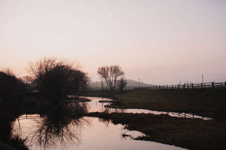 beautiful landscape. morning. the river. fog. trees. reflectionの写真素材