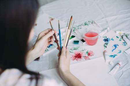 girl artist holds brushes in her hands. creationの写真素材