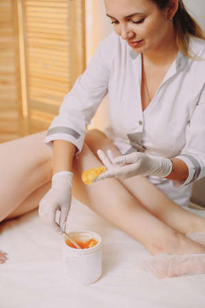 Sugaring: epilation with liquate sugar at legs.の写真素材