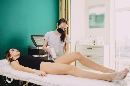 Laser hair removal in professional beauty studio. beauty parlor. Girl master makes hair removal
