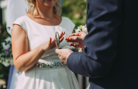 Dressing up the rings at the wedding ceremony close up.