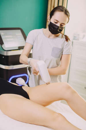Laser hair removal in professional beauty studio. beauty parlor. Girl master makes hair removalの写真素材