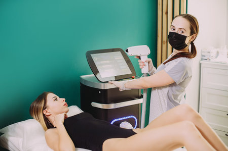 Laser hair removal in professional beauty studio. beauty parlor. Girl master makes hair removalの写真素材