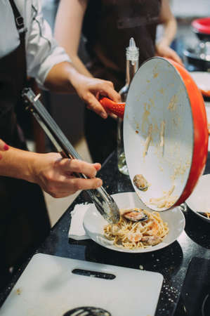 Cooking pasta with seafood in a cooking class. Italian pasta with seafood. Musselsの写真素材
