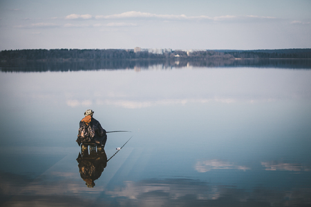 Landscape with a fisherman on the lake Senej, Russia.の写真素材
