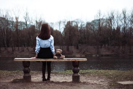 The girl is sitting in the parkの写真素材
