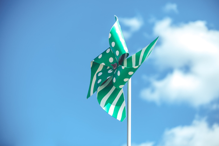 green pinwheel on sky backgr with few cloudsの写真素材