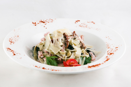 Pasta fettuccine with spinach and scallops isolated on white background. Top viewの写真素材