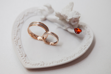 Statue of an angel with wedding rings. Close-up, weddingの写真素材