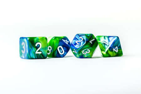 RPG green dice set for playing board games with a spell book on a background. Board games activities.の写真素材