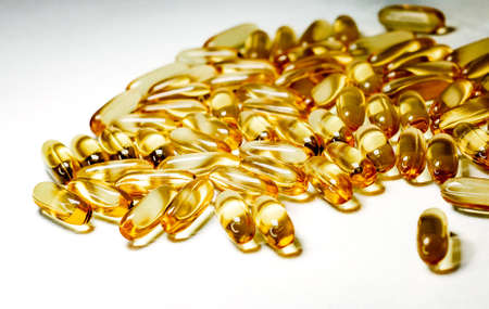 Pharmaceutical medicine colorful pills on the table, capsules on white background. Medicine creative...