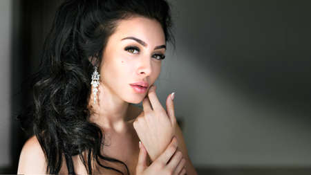 Portrait of beautiful young brunette woman with makeupの写真素材