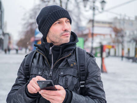 Tourist man looking for th place in GPS application in his smartphone.の写真素材