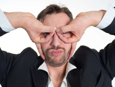 Funny businessman with glasses made of fingers. Airplane pilot.の写真素材