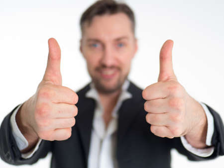 Happy smiling businessman with thumbs up gesture, isolated on white backgroundの写真素材