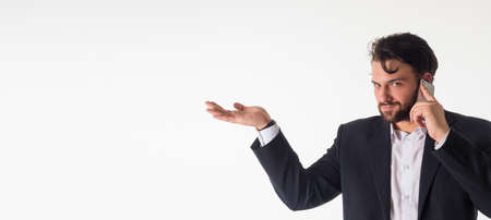 Smiling business man showing open hand palm with copy space for product. Isolated