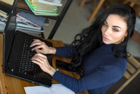 Girl use Laptop huge Loft Studio.Student Researching Process Work.Young Business Woman Working Creative Startup modern Office.Analyze market stock,new strategy. Horizontalの写真素材