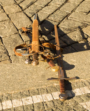 Old rusty swords on the stone floor