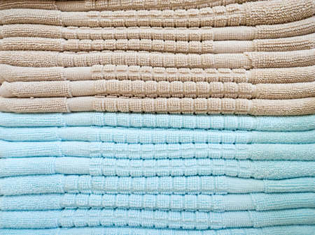 Stack of colorful terry towels folded. Shop Home. Numerous towels stacked and folded on the shelves of a store.の写真素材