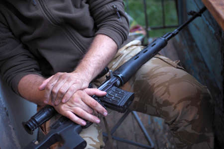 soldier loading a bunch of bullets into a handgun magazineの写真素材