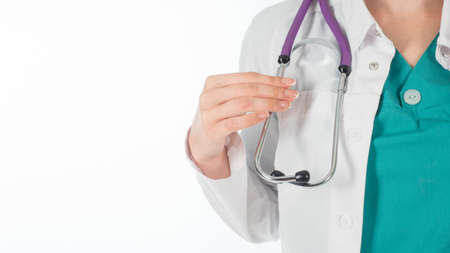 Doctor woman with stethoscope standing isolated on white backgroundの写真素材