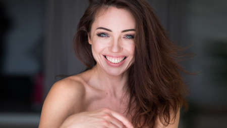 Close-up portrait of an attractive young woman smilingの写真素材