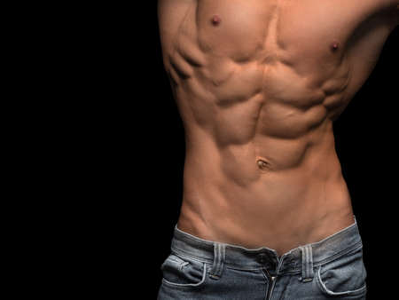 Muscular male torso isolated on black backgroundの写真素材