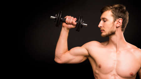 Close up portrait of a man with dumbellの写真素材