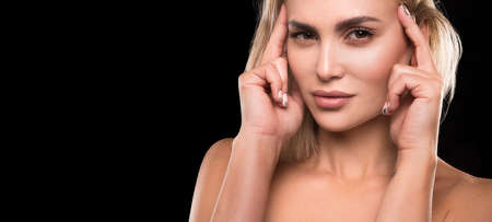 Beautiful woman with professional make up on dark background.の写真素材